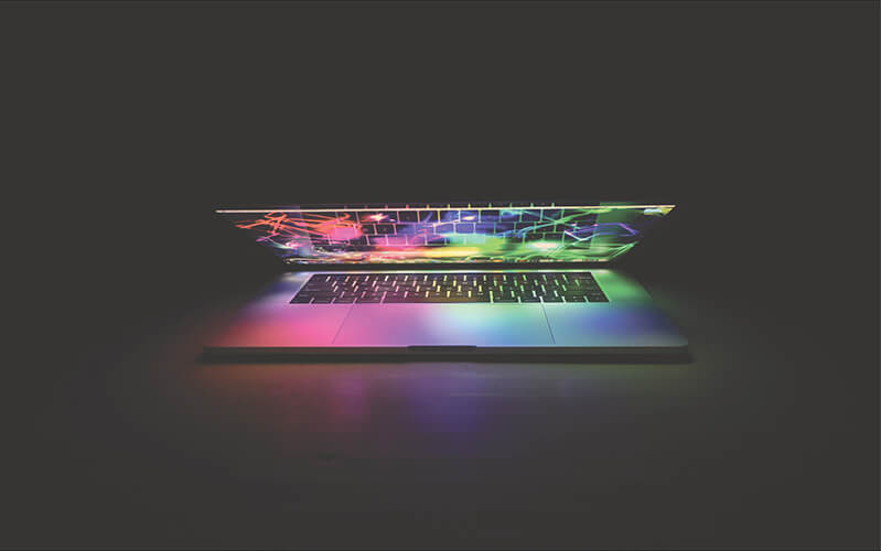 Laptop Glowing In Dark Room