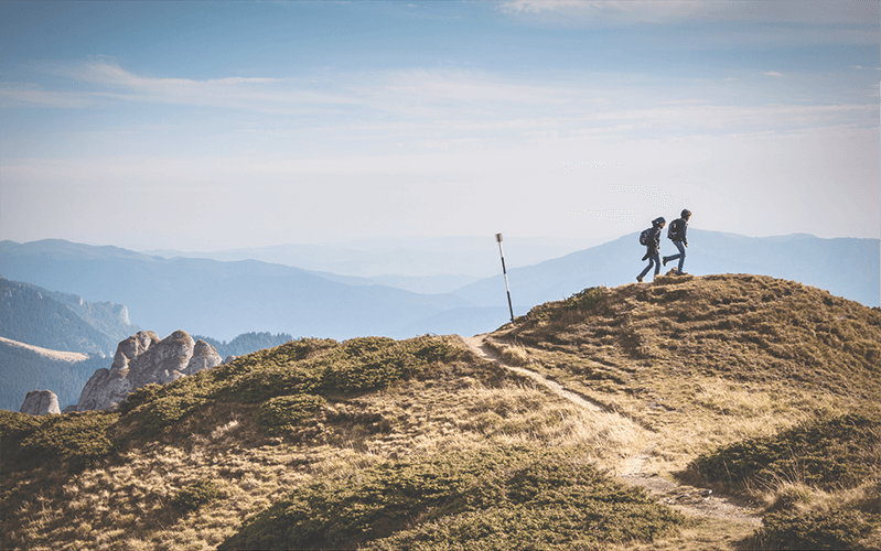 Two people hiking a mountain together