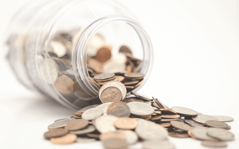 Coins Spilling Out Of A Jar