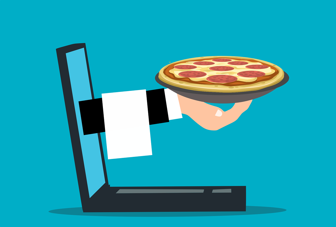 A pizza ordered online coming out of a computer