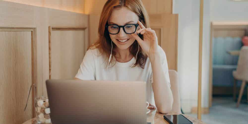 Woman Remote Worker Looks In Laptop Screen