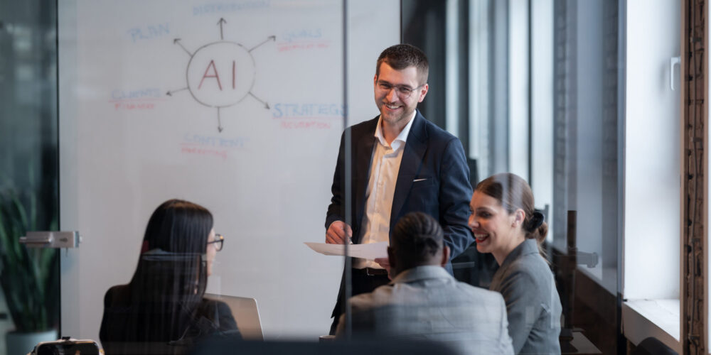 Business team in a modern office during a meeting, discussing AI systems and AI strategy. Concept of AI innovation, teamwork, leadership, corporate planning, professional collaboration