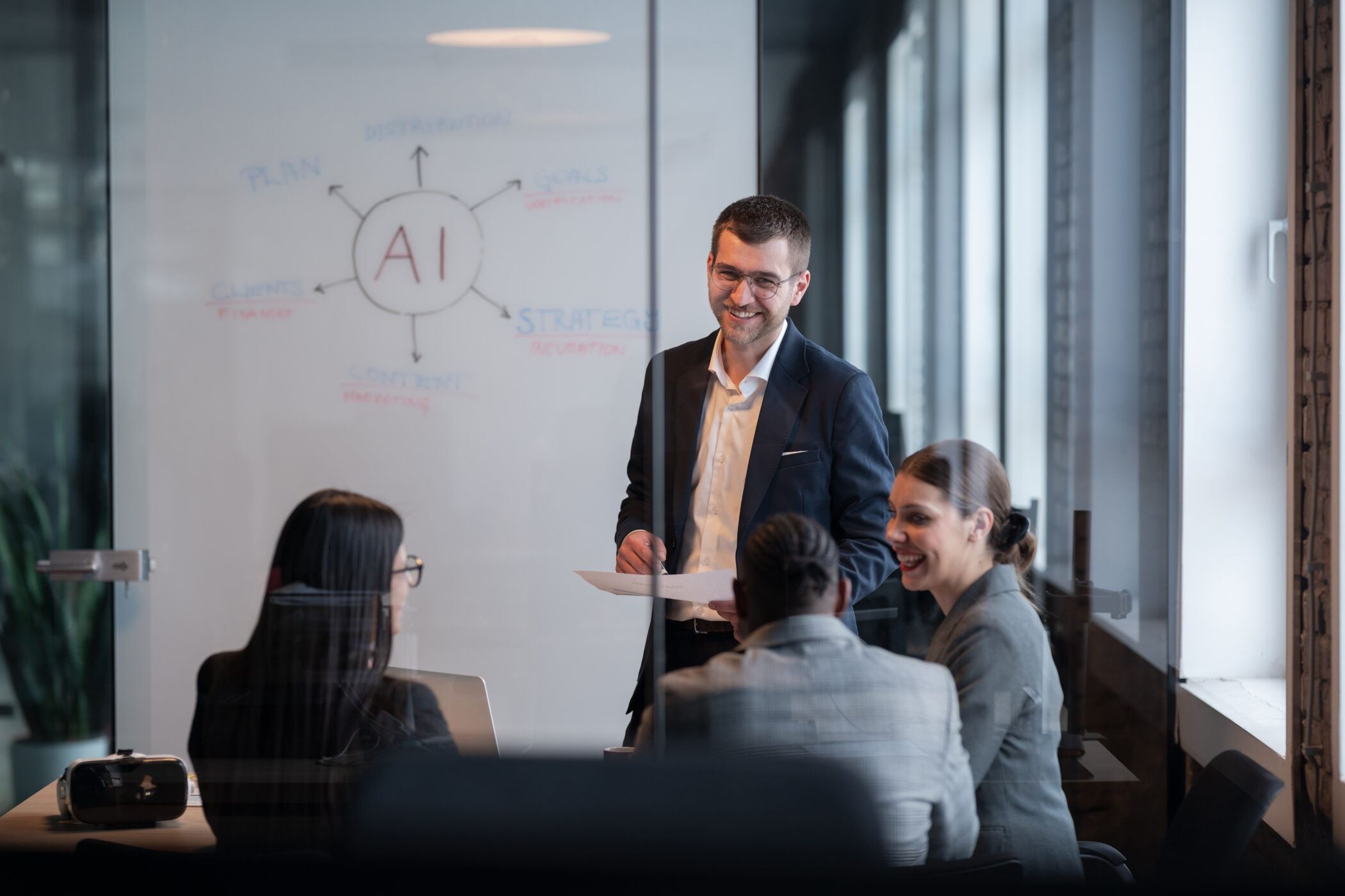 Business team in a modern office during a meeting, discussing AI systems and AI strategy. Concept of AI innovation, teamwork, leadership, corporate planning, professional collaboration