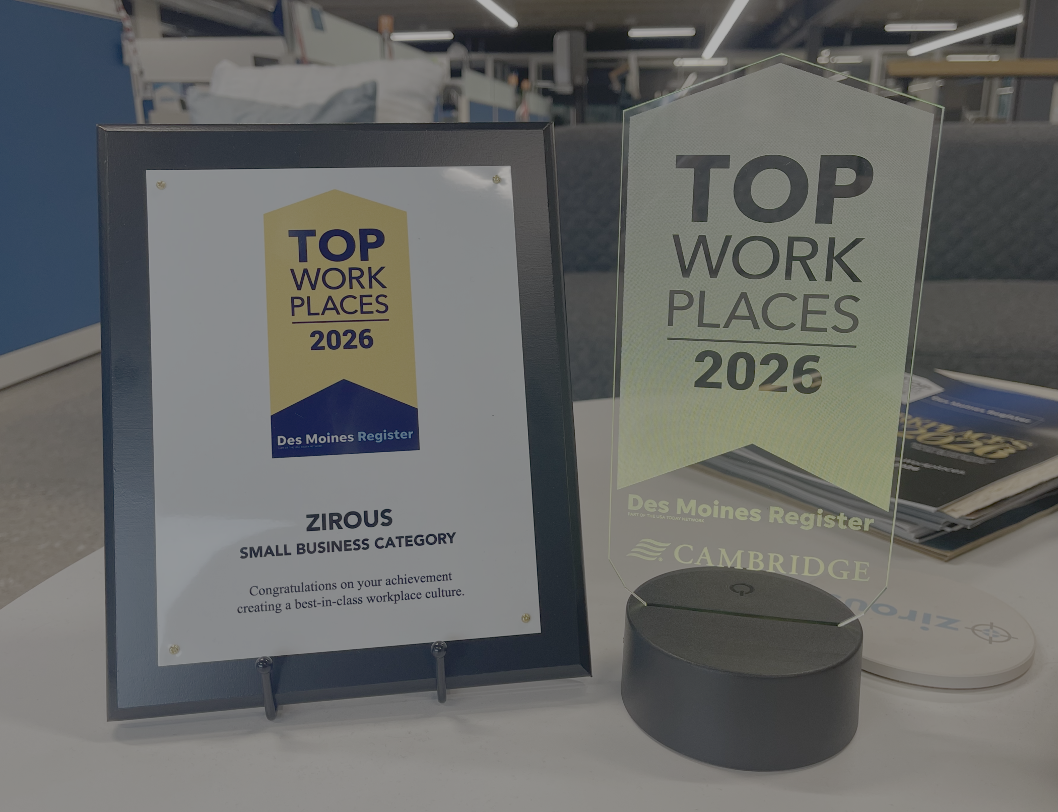 Zirous 2026 Iowa Top Workplace awards from the Des Moines Register displayed at the Zirous office.